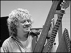 Tom Shinness with his custom electric harp guitar