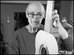 Eugene Clark shows the first stage of assembling  the box, which has the neck and braced top nailed together