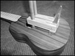 Fred Casey makes some clamps to glue a bridge onto a ukulele