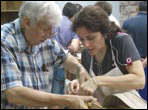 Monica Esparza observes Jose Romanillos shaping a brace