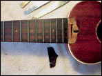 Removing the fretboard extension shows a dovetail joint on a Gibson Uke-2