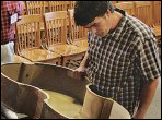 James Condino views a plywood bass that will be restored at the 2011 GAL Convention