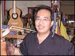 Jeffrey Yong standing in front of a enormous monkey tree stump