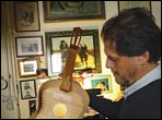 The inside of a guitar on the workbench of Andrea Tacchi