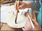 Robert Spear gluing a brace in place on a violin