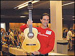 Stephen Marchione polishig a guitar back