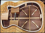 inside view of back and sides of guitar in a form