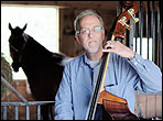 Arnold Schnitzer playing the upright bass in his barn