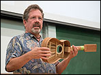 Woodley White holds a ukulele built with a Spanish heel joint