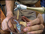 David Freeman using a doorstop spring as a sander