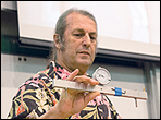 Bob Gleason shows the dial indicator that is mounted on a aluminum beam.