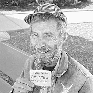 Fred Dickens holds a card that reads I have been vibrated by Carleen