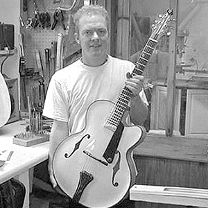 Francois Pistorius holding a archtop guitar