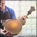 Don MacRostie shows mandolin back after done spraying sunburst colors