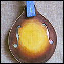 After staining the back, Don MacRostie then stains the top of the mandolin