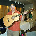 John Calkin holds the guitar that Stephen Kinnaird made