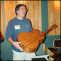 Steve Kinnaird is amazed at the craftmanship of the guitar made by John Calkin