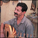 Another view of Blad Boujmaa holding a unfinished oud