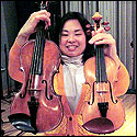 Chien Tan compares a treble violin (right) with a standard violin