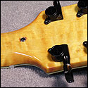 The flush mounted cover is attached via a single screw from the rear of the headstock