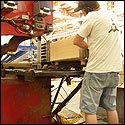 The boards go through a saw with two blades that cuts the width of each board to about ten inches