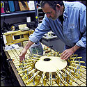 Daniel Fobert uses a series of clamps to glue on a soundboard for a bouzouki