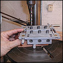 This combination slot head fixture is used to drill tuning machine holes