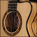 Close up view of soundhole on a harp guitar by Kathy Wingert