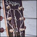 Barbed wire inlay on the headstock of a guitar by Roger Alan Skipper