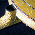 Fancy carving on the neck and heel of a banjo by Roger Alan Skipper