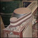 The drum sander fits necks to the curve of the rim.