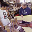 William Eaton supervises Roberto-Venn students making an electric harp guitar of his design