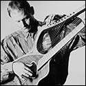 William Eaton with a early harp guitar