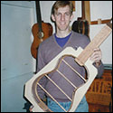 Robbie O'Brien shows a guitar mold with the neck, sides and back braces in place