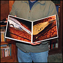 Abel Garcia Lopez showing the book about the Lira de Plata of Leonardo da Vinci.