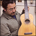 Abel Garcia Lopez holds a historical guitar