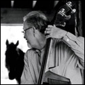 Arnold Schnitzer with a upright bass inside a barn