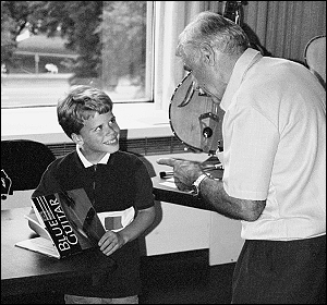 A young boy gets free merchandise from the Scott Chinery Collection, Blue Guitar exhibition