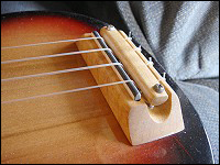 close up view of the bridge of the  ukulele