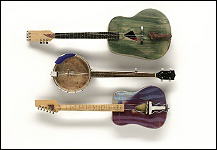 three ceramic instruments, two guitars and one banjo